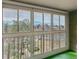 The spacious sunroom has natural light provided by wall to wall windows and a green floor at 3022 S Wheeling Way # 407, Aurora, CO 80014