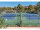 Well-maintained tennis courts with blue and green surfaces offer a great recreational amenity at 3022 S Wheeling Way # 407, Aurora, CO 80014