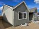 Home exterior showing window detail and green and beige siding at 17146 W 92Nd Loop, Arvada, CO 80007