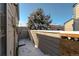 Small fenced backyard with snow and a tree at 1869 S Union Blvd, Lakewood, CO 80228