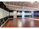 Finished basement with hardwood flooring and decorative wall paneling for enhanced acoustics at 1869 S Union Blvd, Lakewood, CO 80228