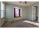 Bedroom with window seat and view, plus carpet flooring at 1869 S Union Blvd, Lakewood, CO 80228