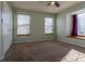 Well-lit bedroom featuring two windows and a ceiling fan at 1869 S Union Blvd, Lakewood, CO 80228