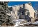 Tan exterior home with blue accents and snowy landscaping at 1869 S Union Blvd, Lakewood, CO 80228