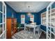 Charming home office with dark blue walls and built-in shelving at 10535 Starglow Ct, Highlands Ranch, CO 80126