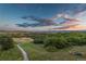 Scenic walking path through green space with mountain views at sunset at 10535 Starglow Ct, Highlands Ranch, CO 80126