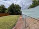Backyard view featuring green lawn area and a fenced perimeter, providing a private outdoor space at 2285 S Knox Ct, Denver, CO 80219