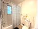 Well-lit bathroom with shower-tub combination, toilet, and tile accents at 2285 S Knox Ct, Denver, CO 80219