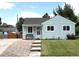 Charming single-story home with light blue siding, a well-manicured lawn, and inviting curb appeal at 2285 S Knox Ct, Denver, CO 80219