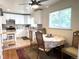 Eat-in kitchen with dining table, white cabinets, stainless steel appliances, and a bright window at 2285 S Knox Ct, Denver, CO 80219