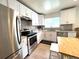 Bright kitchen boasts stainless steel appliances and ample counter space for cooking at 2285 S Knox Ct, Denver, CO 80219