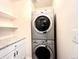 Convenient laundry area featuring a stacked washer and dryer unit and storage at 2285 S Knox Ct, Denver, CO 80219
