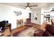Open living room featuring a ceiling fan and hardwood floors leading to kitchen at 2285 S Knox Ct, Denver, CO 80219