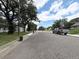 Street view showcasing a peaceful residential neighborhood with trees, sidewalks, and various homes at 2285 S Knox Ct, Denver, CO 80219