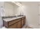 Bathroom with double sink vanity featuring granite countertops, ample lighting, and modern fixtures at 23688 E Ida Dr # E, Aurora, CO 80016