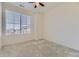 Bright bedroom with carpet, a ceiling fan, and a window offering natural light and exterior scenery at 23688 E Ida Dr # E, Aurora, CO 80016