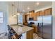 Well-lit kitchen with granite countertops, stainless steel appliances, and bar seating at 23688 E Ida Dr # E, Aurora, CO 80016