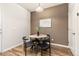 Cozy dining area with wood-look floors, a round table, and modern black chairs at 8183 S Yosemite Ct, Centennial, CO 80112