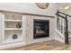 Charming fireplace with stone surround and built-in shelving for decorative items at 8183 S Yosemite Ct, Centennial, CO 80112
