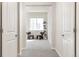 Bright hallway leads to a bedroom with stylish furniture and a view from the window at 8183 S Yosemite Ct, Centennial, CO 80112