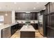 Well-lit kitchen featuring stainless appliances, dark wood cabinets, granite countertops and a kitchen island at 8183 S Yosemite Ct, Centennial, CO 80112