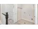 Upstairs laundry room with tile floors, shelving, and washer/dryer hookups at 8183 S Yosemite Ct, Centennial, CO 80112