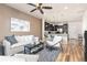 Bright open-concept living room features a ceiling fan and modern kitchen with breakfast bar at 8183 S Yosemite Ct, Centennial, CO 80112