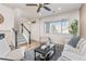 Sun-filled living room with staircase, large windows, and stylish décor at 8183 S Yosemite Ct, Centennial, CO 80112