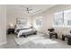 Bright main bedroom features tray ceiling, large windows, and neutral decor for a serene retreat at 8183 S Yosemite Ct, Centennial, CO 80112