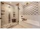 Modern bathroom features glass-enclosed shower, soaking tub, and stylish tile work at 2235 S Cherokee St, Denver, CO 80223