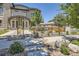 Attractive home showcasing a modern design, stone accents, and well-maintained landscaping with a cozy seating area at 2235 S Cherokee St, Denver, CO 80223