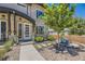 Charming home with a stone facade, manicured landscaping, and a welcoming front porch with seating area at 2235 S Cherokee St, Denver, CO 80223