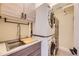 Well-equipped laundry area with stacked washer/dryer and convenient sink at 2235 S Cherokee St, Denver, CO 80223