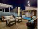 Evening view of the backyard deck with a hot tub and string lights at 2235 S Cherokee St, Denver, CO 80223