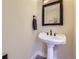 Powder room with stylish pedestal sink, modern fixtures, and clean design at 2235 S Cherokee St, Denver, CO 80223