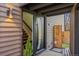 Modern entryway with a sleek front door, wood siding, and access to the staircase at 1485 S Jasmine Way, Denver, CO 80224