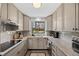 This updated kitchen features granite countertops, stainless steel appliances, and a window view of the backyard at 1485 S Jasmine Way, Denver, CO 80224