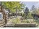 Landscaped backyard with patio, garden, and mature trees at 2825 Elm Ave, Boulder, CO 80305