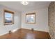 Simple bedroom with hardwood floors and two windows at 2825 Elm Ave, Boulder, CO 80305