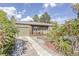 Quaint ranch home with a stone pathway and lush landscaping at 2825 Elm Ave, Boulder, CO 80305