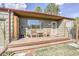 Inviting front porch with wooden chairs and a small table at 2825 Elm Ave, Boulder, CO 80305