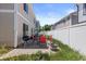 Cozy backyard patio with outdoor seating, grill, and white privacy fence at 19817 E 47Th Pl, Denver, CO 80249