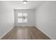 Neutral bedroom with wood-look flooring, a window and ample natural light at 19817 E 47Th Pl, Denver, CO 80249