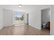 Spacious bedroom with wood-look flooring, a large window, and access to a bathroom at 19817 E 47Th Pl, Denver, CO 80249