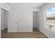 Bright bedroom featuring wood-look flooring and a closet with a door frame for easy access at 19817 E 47Th Pl, Denver, CO 80249