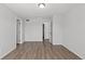 Well-lit bedroom with wood-look flooring, multiple entryways, and ample space at 19817 E 47Th Pl, Denver, CO 80249