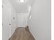 Clean, bright entryway with hardwood floors, white walls, and a coat closet at 19817 E 47Th Pl, Denver, CO 80249