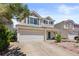 Two-story home with attached two-car garage, neutral siding and green shutters in a residential neighborhood at 19817 E 47Th Pl, Denver, CO 80249