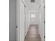 Hallway with closet space showcasing modern wood-look floors and neutral paint at 19817 E 47Th Pl, Denver, CO 80249