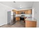 Well-equipped kitchen with stainless steel appliances, wood cabinets and ample counter space at 19817 E 47Th Pl, Denver, CO 80249